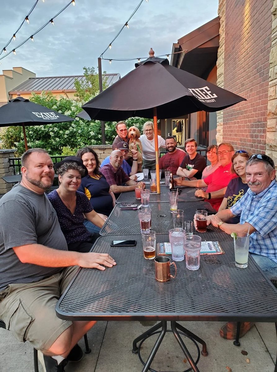 Reed with friends around a patio dinner table