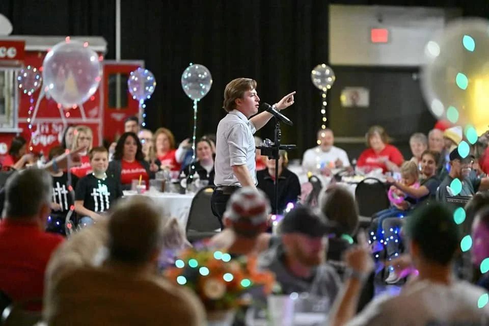 Reed performing for a crowd at an event